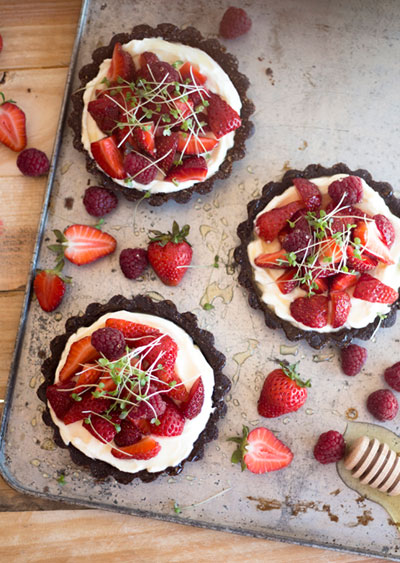 Tartlets with red fruits and microgreens